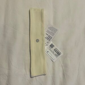 Lululemon Fly Away Tamer Ivory Headband with Logo.
